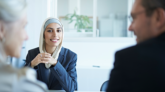 Lady smiling at the screen during a meeting