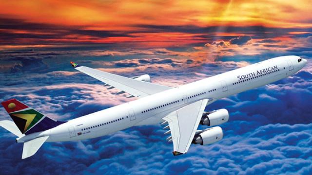 plane over water sunset in background