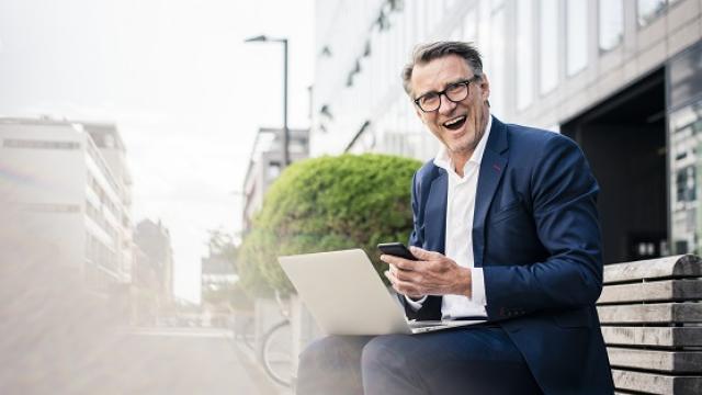 Male on phone and laptop