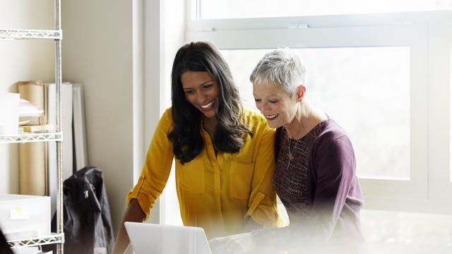 Two females working together to understand travel credits
