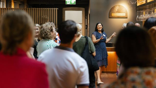Women speaking in from of crowd 