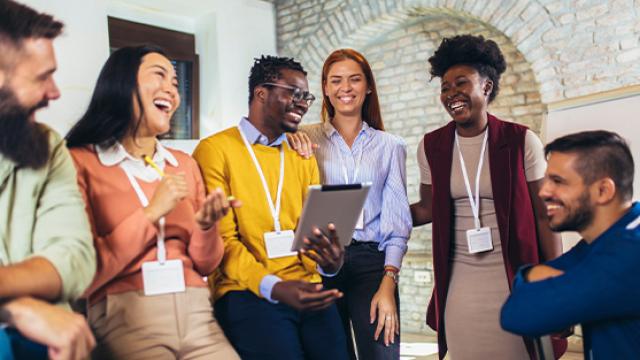 people standing around discussing and smiling