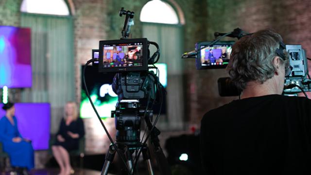 Men looking through film camera preview