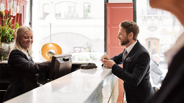 Man at hotel reception checking in