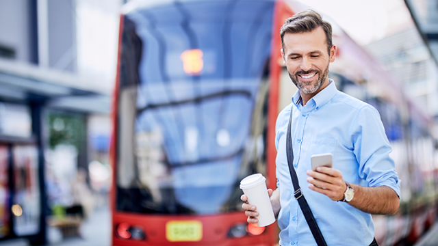 Safety and risk, man on mobile in front of a bus