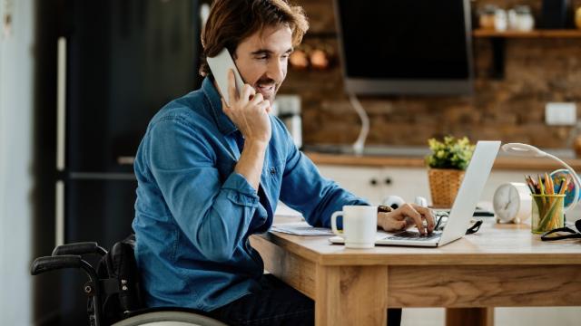 Man on the phone and working on his laptop