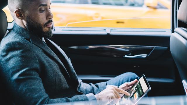 VIP traveller checking numbers on his tablet