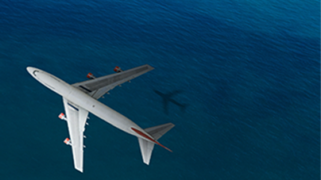 birds eye view of a plane flying above the ocean