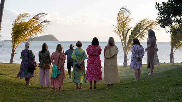 group of people standing on beachfront receiving training