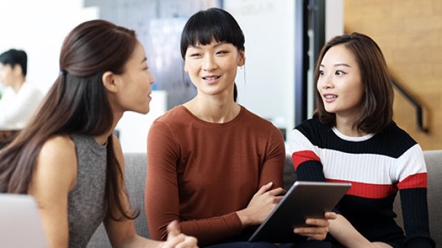 3 women talking and smiling 