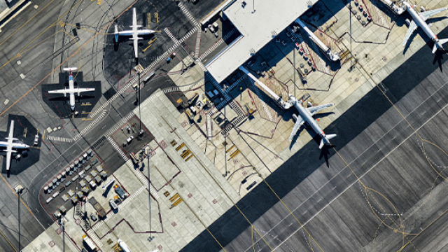 birds eye view of planes docked at an airport