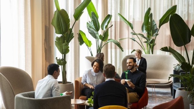 miling entrepreneurs discussing while sitting in office.jpg
