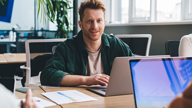 A man creating a strategy on a laptop