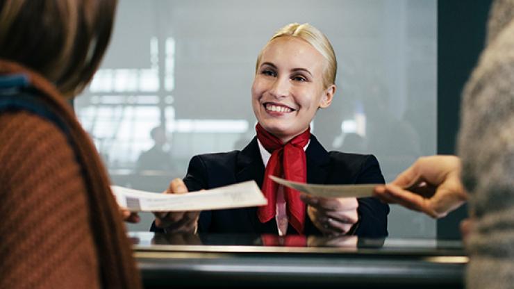 woman serving plane tickets