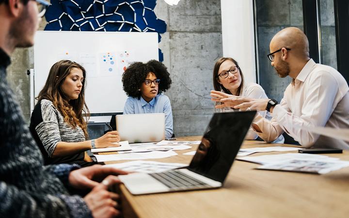 Team discussing together in meeting room