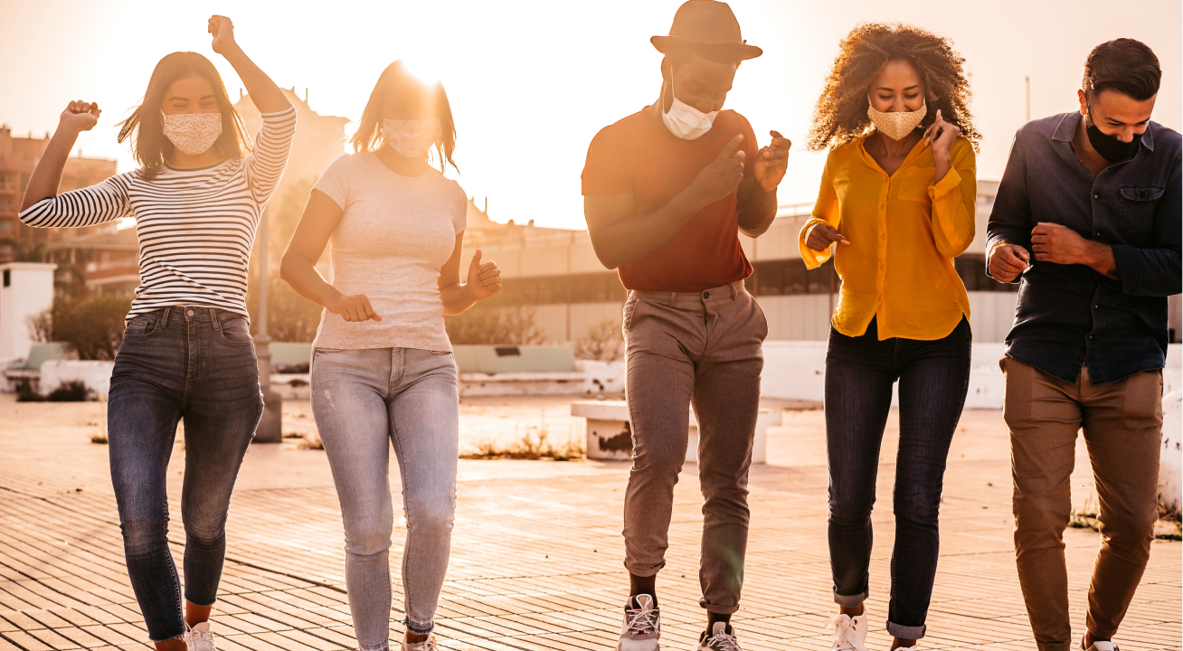 People dancing in the street at sunset