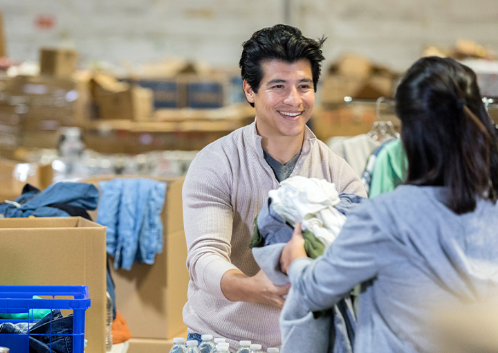 Volunteers packing boxes of clothes