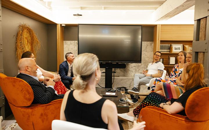 People sitting in room discussing 