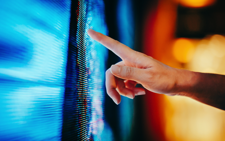 Person pointing at a screen