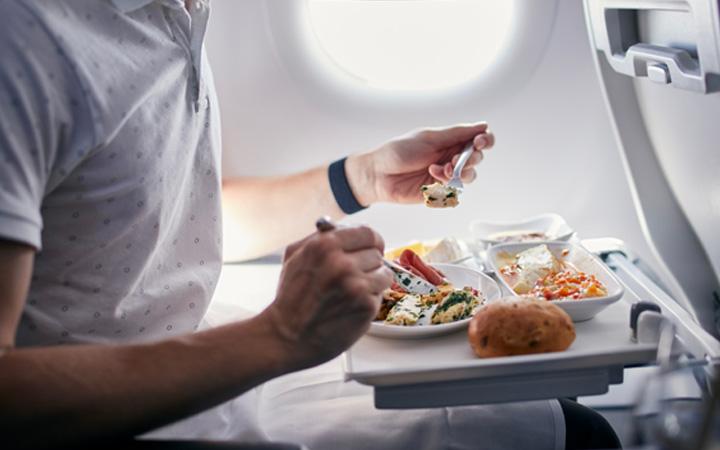 man eating on plane