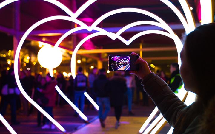 Person taking pictures of a light display 