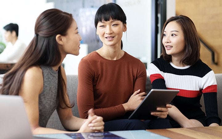 3 women talking and smiling 