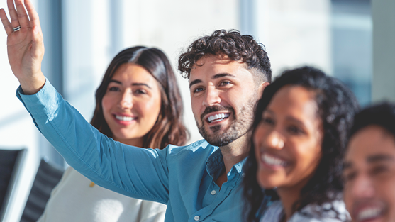 Man with a hand up, asking a question