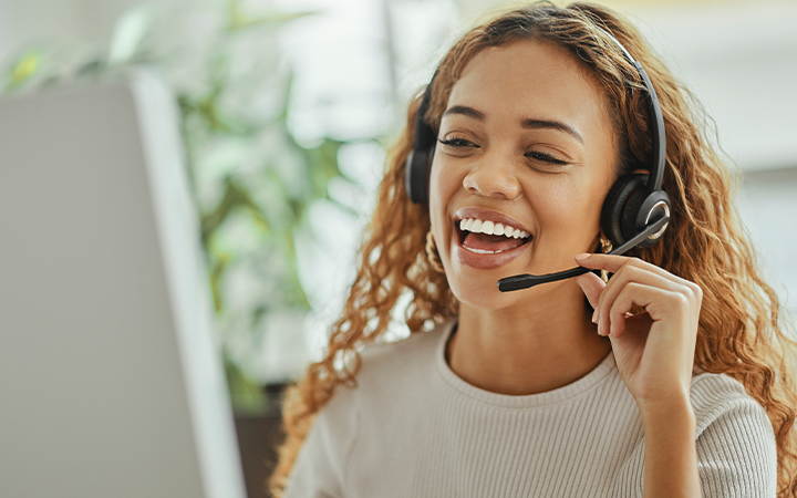 lady smiling, speaking on a headset