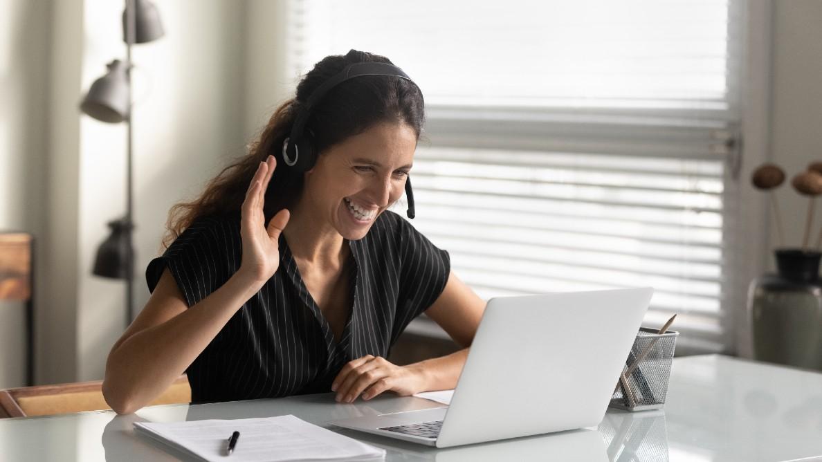 Woman smiling and waving on a virtual call