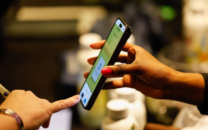 A smartphone being held while someone touches the screen