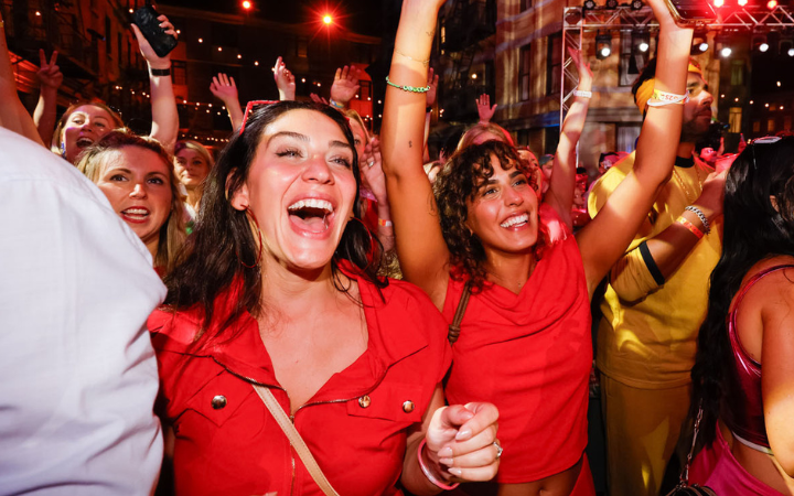 Excited people in a crowd wearing red