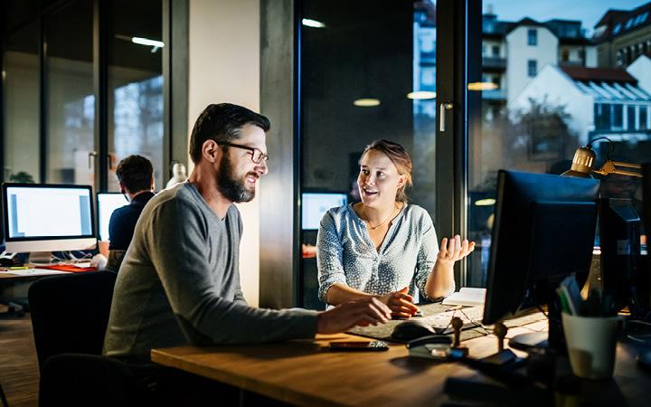 Two people sitting at a desk