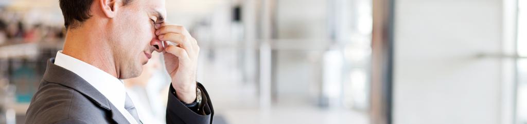 Tired business man sitting with head in hands