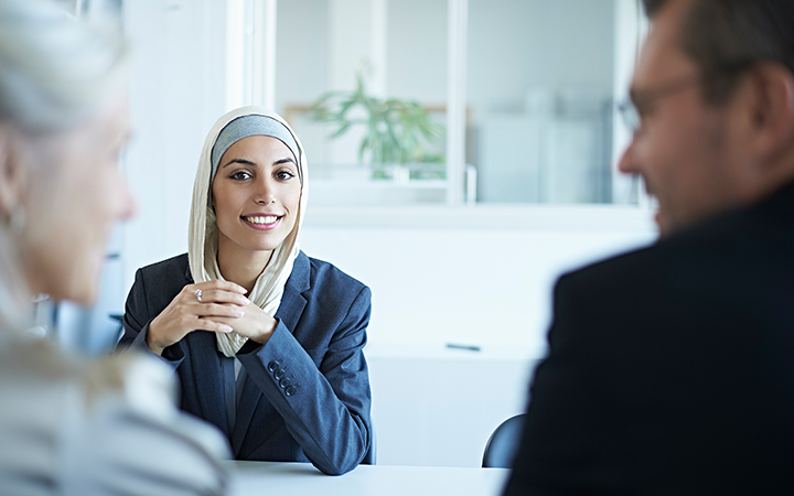 Lady smiling at the screen during a meeting