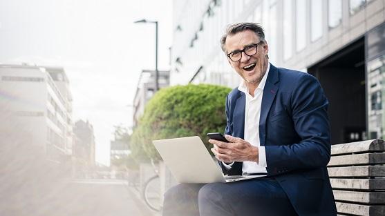 Male on phone and laptop