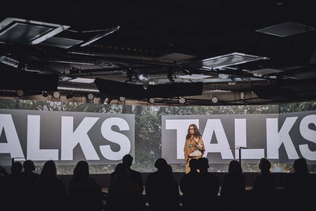 Female pubic speaker giving speech to audience
