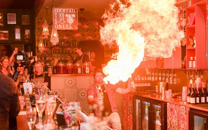 Man blowing fire from mouth in restaurant