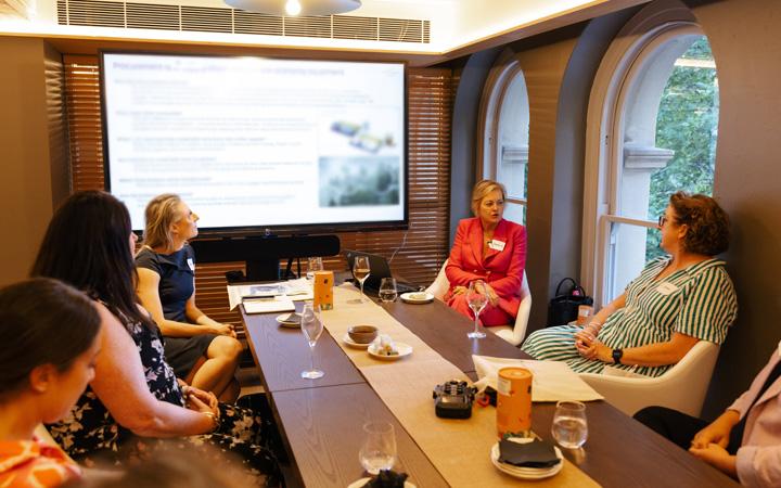 people sitting around table in discussion 