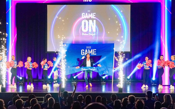 Speaking on stage in front of crowd