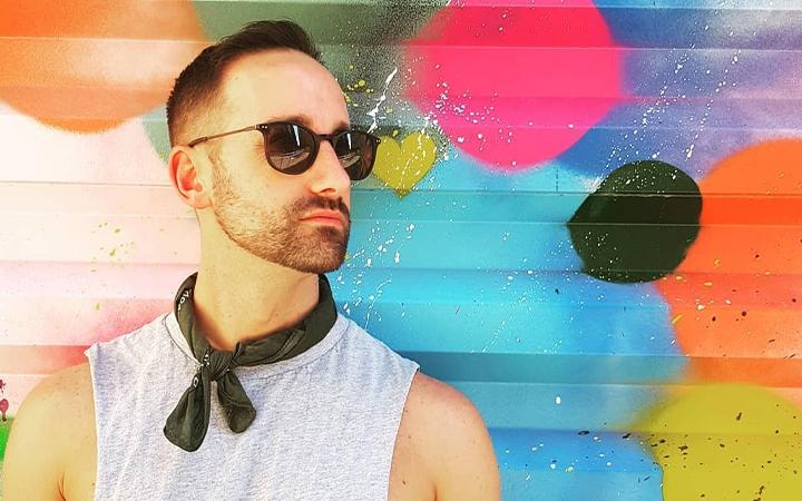 Man in front of colourful wall