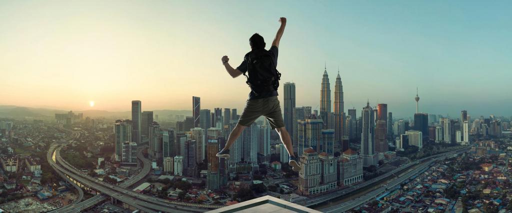 Male traveller jumping with excitement against Malaysia skyline