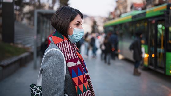 Lady with Mask waiting for Bus
