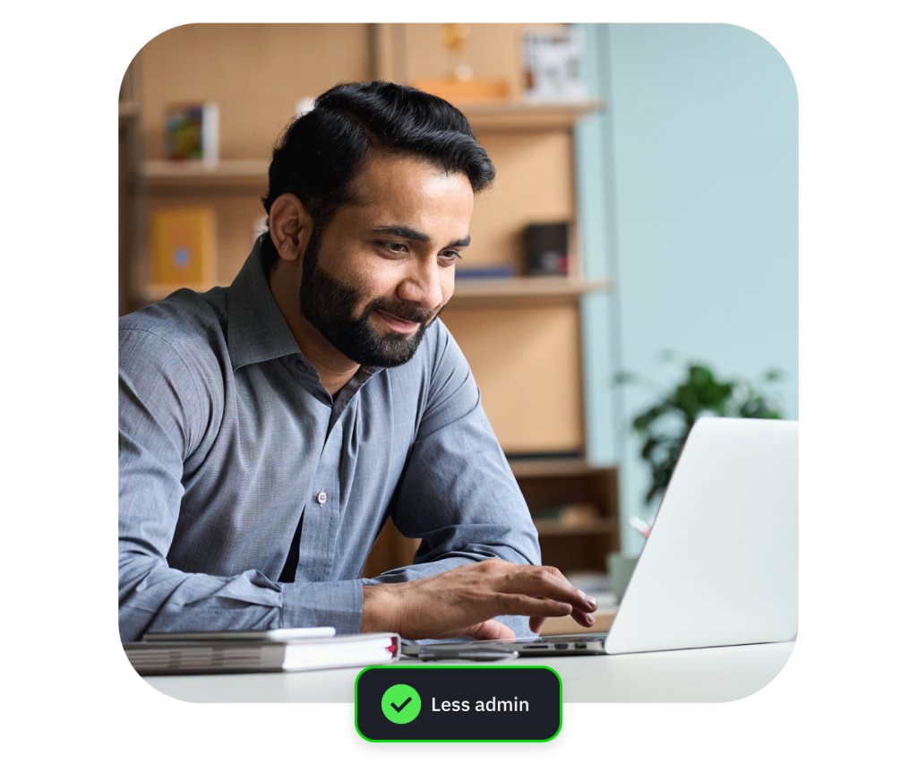 Smiling bearded man holding pen at laptop, with green “Less admin” badge.