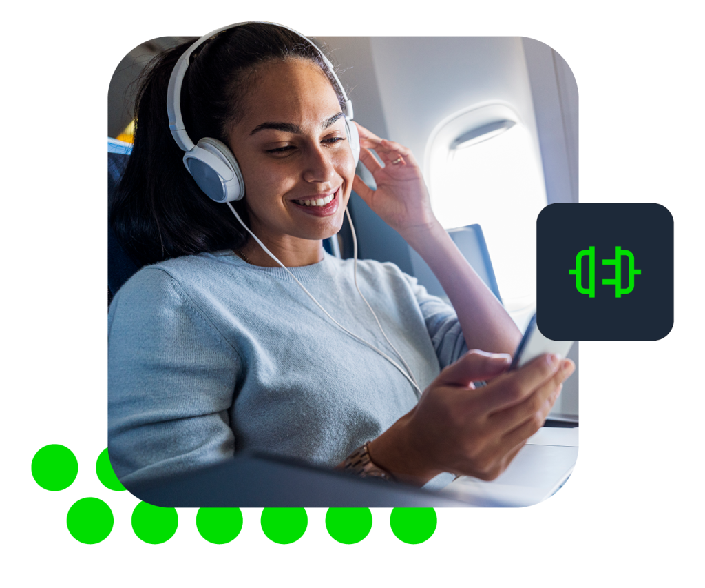 Photo of woman wearing headphones and holding smartphone in airplane seat, green audio icon overlay