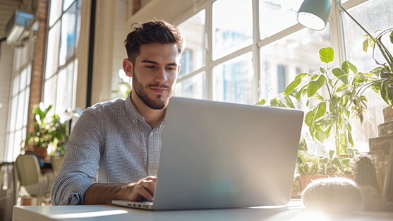 A man on a laptop, completing the FCM platform demo