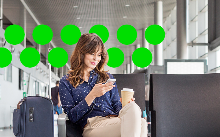 woman looking at her phone smiling