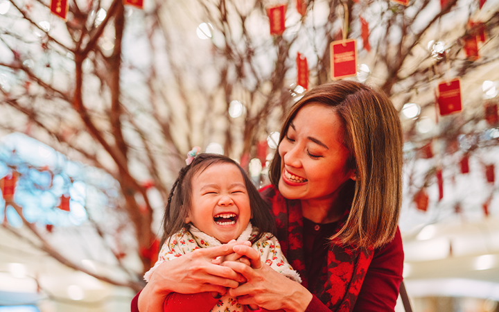 mother and daughter smiling and laughing