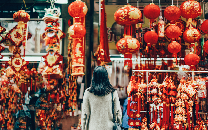 women standing in front of lanterns 