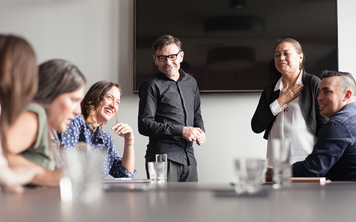 People sitting around a meeting table at work 