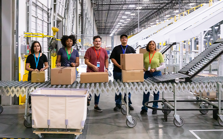 warehouse team packing looking forward and smiling
